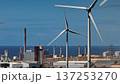 Tenerife, Canary Islands: Wind turbines generating clean energy alongside a coastal power plant in Tenerife, highlighting the shift to sustainable energy. Static shot Tenerife, Canary Islands: Wind turbines generating clean energy alongside a coastal power plant in Tenerife, highlighting the shift to sustainable energy. Static shot 137253270