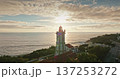 Portugal, Lisbon: Guia Lighthouse standing on the coast, near Cascais, during a beautiful warm light sunset, with sun rays bathing the structure and illuminating the ocean. Aerial drone panorama Portugal, Lisbon: Guia Lighthouse standing on the coast, near Cascais, during a beautiful warm light sunset, with sun rays bathing the structure and illuminating the ocean. Aerial drone panorama 137253272