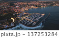 Portugal, Lisbon: Cascais at dusk, breathtaking aerial view showcasing the illuminated night cityscape, marina filled with boats, and the mesmerizing coastline meeting the ocean waves. Drone Portugal, Lisbon: Cascais at dusk, breathtaking aerial view showcasing the illuminated night cityscape, marina filled with boats, and the mesmerizing coastline meeting the ocean waves. Drone 137253284