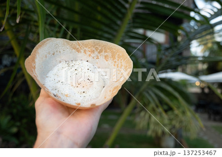 Sri Lanka street food hopper with egg in hand outdoors Sri Lanka street food hopper with egg in hand outdoors 137253467