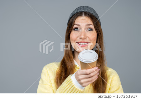 Young woman in yellow sweater having coffee and feeling good Young woman in yellow sweater having coffee and feeling good 137253917