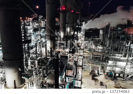 Oil refinery at night lit. Construction of an oil industrial fac 137254063