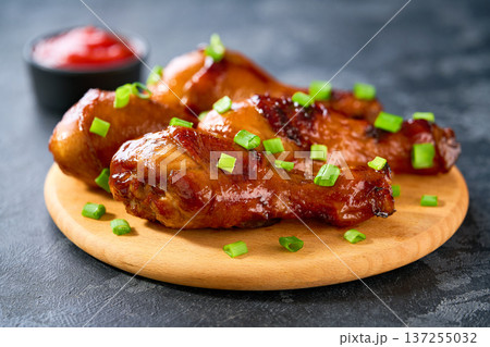 Fried chicken legs with sauce on a black table, selective focus. Fried chicken legs with sauce on a black table, selective focus. 137255032