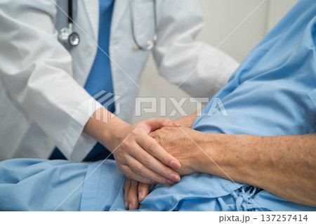 Asian doctor checking and treat elderly woman patient health in hospital. 137257414