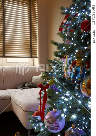 Warm and inviting display of festive glass baubles and ribbons 137258093