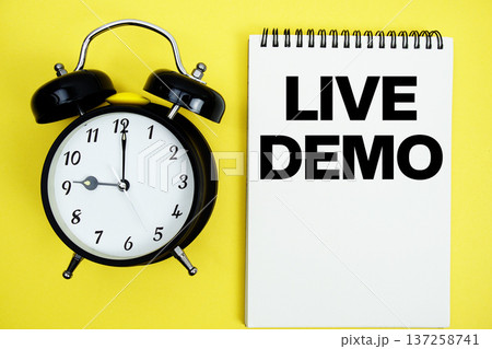 Live Demo text with alarm clock flat lay on yellow background Live Demo text with alarm clock flat lay on yellow background 137258741