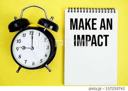 Make An Impact text with alarm clock flat lay on yellow background Make An Impact text with alarm clock flat lay on yellow background 137258742
