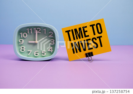 Time To Invest text and alarm clock on blue and purple background 137258754