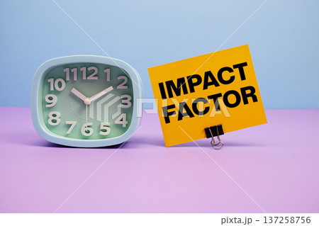 Impact Factor text and alarm clock on blue and purple background Impact Factor text and alarm clock on blue and purple background 137258756