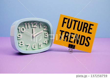 Future Trends text and alarm clock on blue and purple background Future Trends text and alarm clock on blue and purple background 137258759