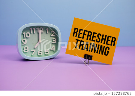 Refresher Training text and alarm clock on blue and purple background Refresher Training text and alarm clock on blue and purple background 137258765