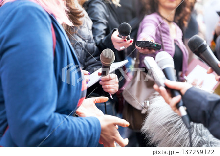 Public figure talking to the media, journalists holding microphones at news conference Public figure talking to the media, journalists holding microphones at news conference 137259122