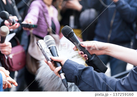 Journalists holding microphones at press conference Journalists holding microphones at press conference 137259160
