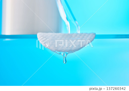 Cotton pad soaking liquid with dripping clean water 137260342