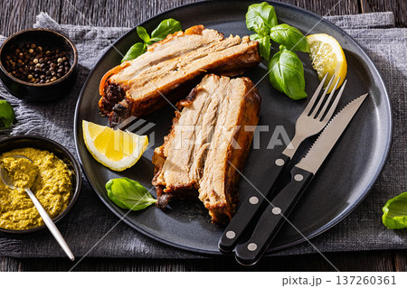 Roasted pork belly ribs with pesto and lemon Roasted pork belly ribs with pesto and lemon 137260361