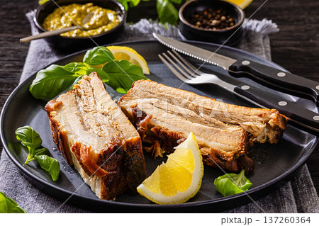 Roasted pork belly ribs with pesto and lemon Roasted pork belly ribs with pesto and lemon 137260364