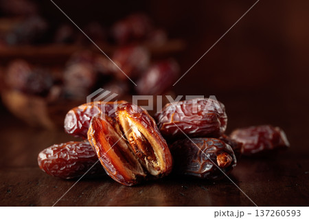 Dates fruit on an old wooden table. Dates fruit on an old wooden table. 137260593