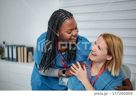 Two happy nurses enjoying a friendly moment at work 137260809