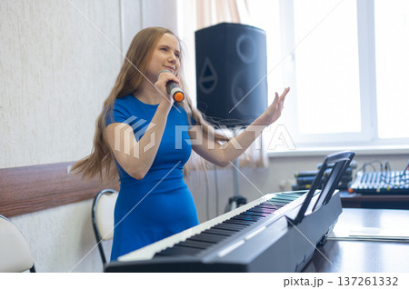 Caucasian woman singing into microphone.  137261332