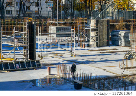 Urban Construction Site with Concrete Slabs Rebar Columns and Scaffolding Urban Construction Site with Concrete Slabs Rebar Columns and Scaffolding 137261364