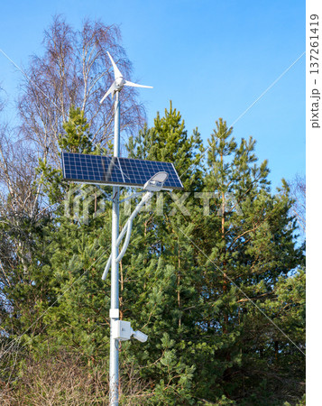 Solar Panel and Wind Turbine Street Light with surveillance camera in Forest Setting 137261419