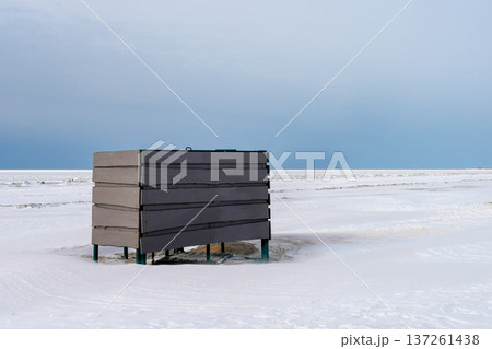 Beach Changing Cabin Surrounded by Snow on Baltic Sea Coast in Winter Beach Changing Cabin Surrounded by Snow on Baltic Sea Coast in Winter 137261438