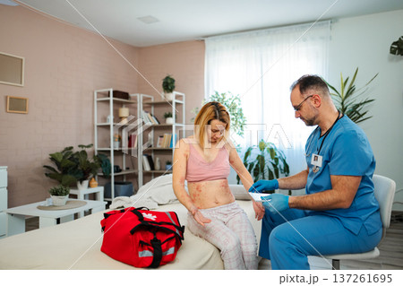 Doctor examining woman with skin rash during home visit Doctor examining woman with skin rash during home visit 137261695