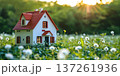 Brightly lit house surrounded by lush greenery and flowers during early morning light 137261936