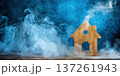 Wooden house model surrounded by smoke creating a unique home and cleaning concept 137261943