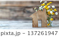 Wooden house symbol and fresh flowers creating a cozy home atmosphere 137261947