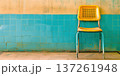 Bright yellow chair against turquoise wall in a clean, furnished room setting 137261948