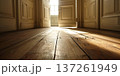 Sunlight illuminating a rustic wooden floor through an open door in a clean room setting 137261949