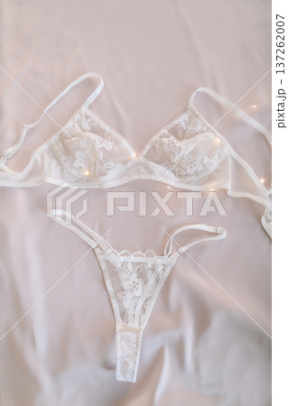Woman's lingerie on the bed sheets. Lace sexy female underwear. Beauty, fashion blogger concept. Female bra, panties, erotic clothes. Lingerie advertising Woman's lingerie on the bed sheets. Lace sexy female underwear. Beauty, fashion blogger concept. Female bra, panties, erotic clothes. Lingerie advertising 137262007