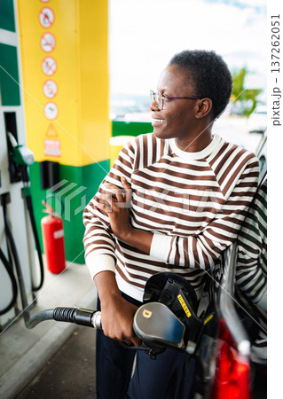 Young woman refueling car with diesel at gas station Young woman refueling car with diesel at gas station 137262051
