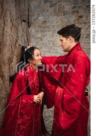 Interracial couple celebrating traditional Chinese wedding wearing hanfu Interracial couple celebrating traditional Chinese wedding wearing hanfu 137262074