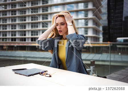 Stressed businesswoman experiencing burnout and work pressure in city 137262088