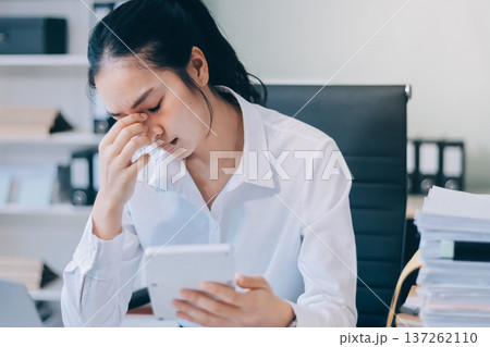 Asian business woman experiences work stress headache in modern office reviewing financial report data analysis overwhelmed professional employee burnout difficult project Asian business woman experiences work stress headache in modern office reviewing financial report data analysis overwhelmed professional employee burnout difficult project 137262110