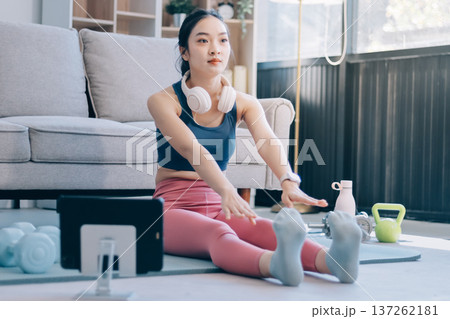 Young Asian sporty attractive people practicing yoga lesson with instructor. Asia group of women exercising healthy lifestyle in fitness studio. Sport activity, gymnastics or ballet dancing class. 137262181