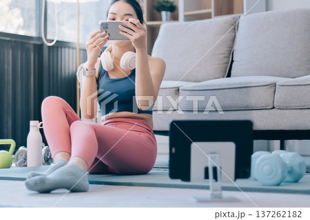 Young Asian sporty attractive people practicing yoga lesson with instructor. Asia group of women exercising healthy lifestyle in fitness studio. Sport activity, gymnastics or ballet dancing class. 137262182