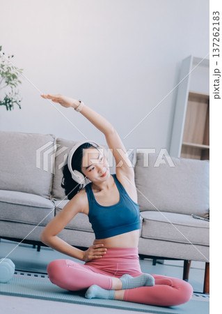 Young Asian sporty attractive people practicing yoga lesson with instructor. Asia group of women exercising healthy lifestyle in fitness studio. Sport activity, gymnastics or ballet dancing class. 137262183