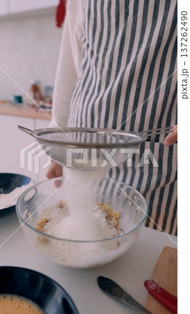 Baking process captured. Precise baking involves delicate dusting Baking process captured. Precise baking involves delicate dusting 137262490