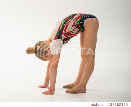 Gymnast girl with cochlear implant doing split pose on hands. Empowerment, flexibility, and hearing inclusion through movement and artistic expression. Gymnast girl with cochlear implant doing split pose on hands. Empowerment, flexibility, and hearing inclusion through movement and artistic expression. 137262530