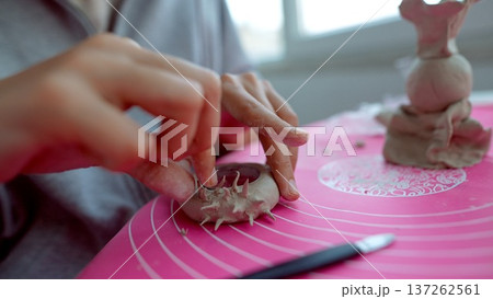 Meticulous handcrafting of small clay ornaments with detailed textures Meticulous handcrafting of small clay ornaments with detailed textures 137262561