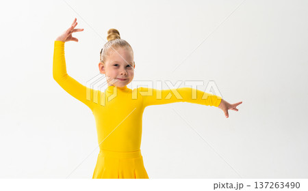 Young dancer with cochlear implant performing dance pose. Strength, adaptability, and inclusion merge in a story of overcoming hearing barriers through art, discipline, and body control. 137263490