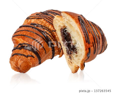Chocolate Drizzled Croissant with Creamy Filling Isolated on Light Background Chocolate Drizzled Croissant with Creamy Filling Isolated on Light Background 137263545