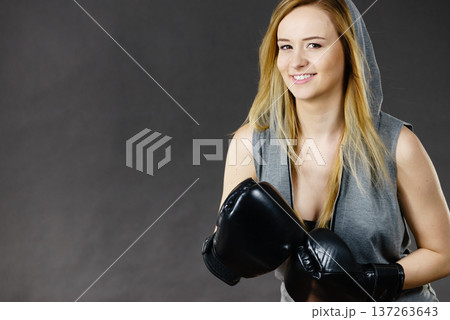 Boxer girl exercise with boxing gloves. 137263643