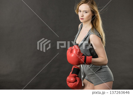 Woman wearing boxing gloves Woman wearing boxing gloves 137263646