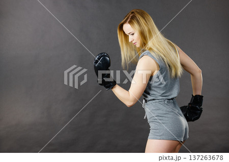 Boxer girl exercise with boxing gloves. Boxer girl exercise with boxing gloves. 137263678