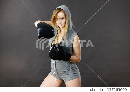 Boxer girl exercise with boxing gloves. Boxer girl exercise with boxing gloves. 137263690