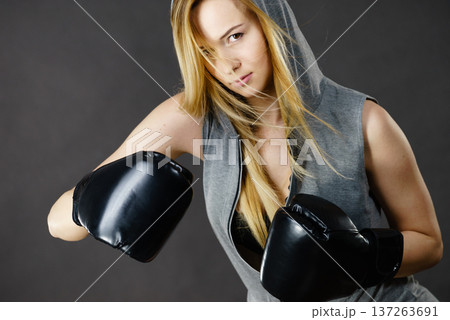 Boxer girl exercise with boxing gloves. Boxer girl exercise with boxing gloves. 137263691